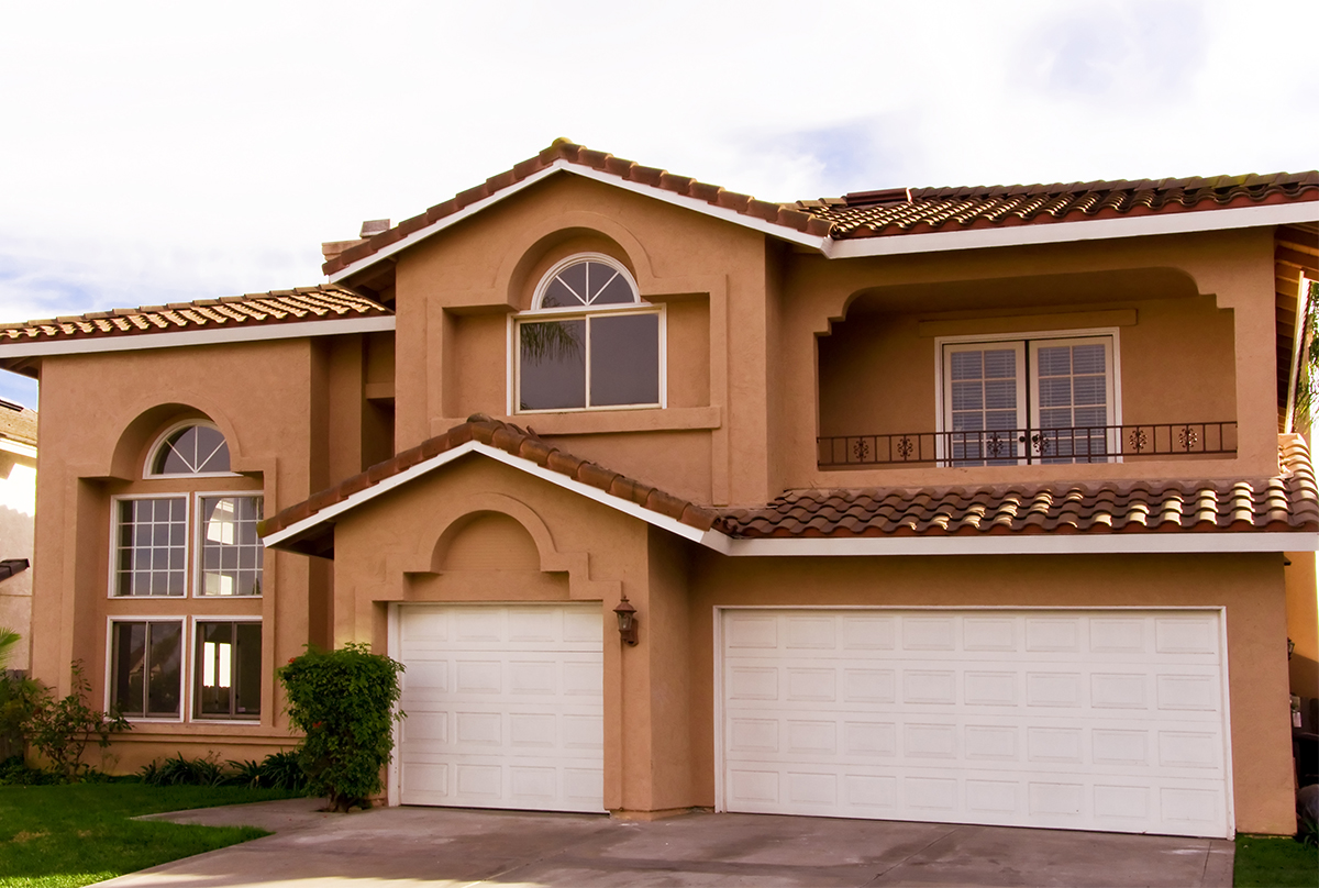 Two story orange home with three car garage.